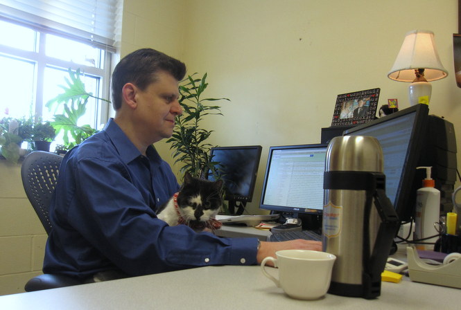 Alex at his desk at work